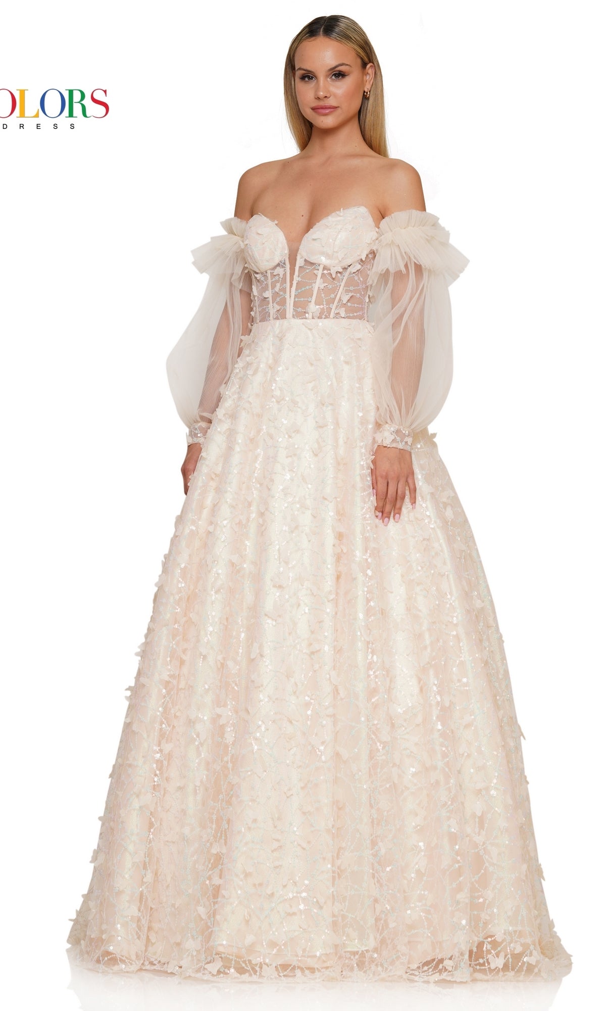 A woman wears the 3D Butterfly Formal Ball Gown 3226, featuring a light pink hue, off-the-shoulder fitted bodice, floral and butterfly accents, and removable sheer long sleeves against a white background.
